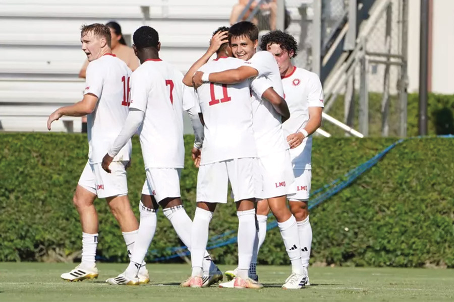 LMU men's soccer team embraces after win