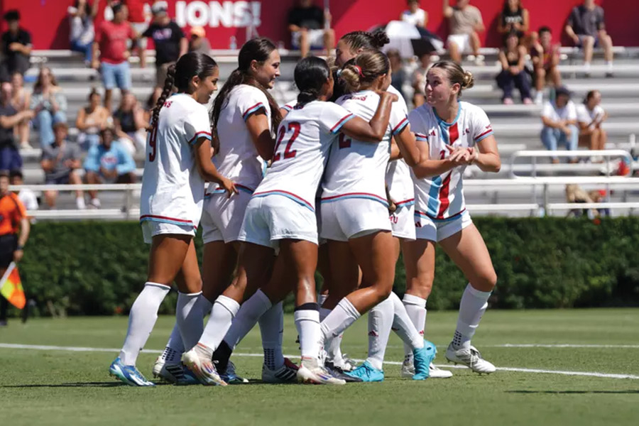 LMU Womens Soccer Team embraces after beating Columbia