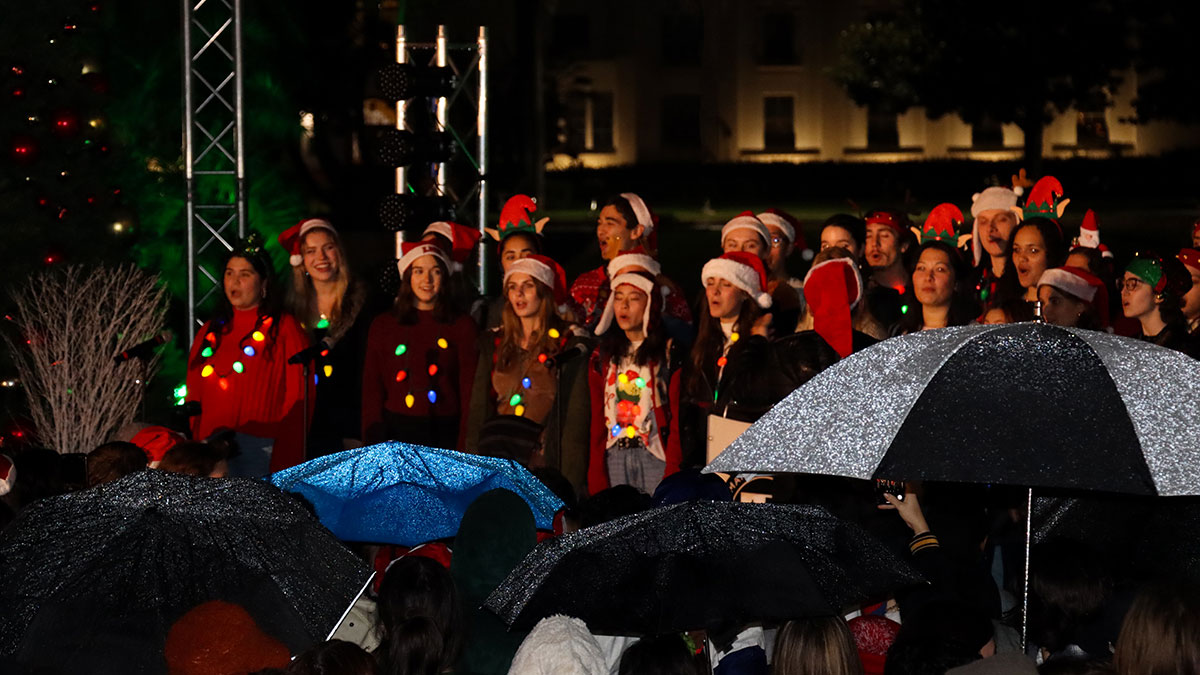 A large choir of students singing Christmas carols