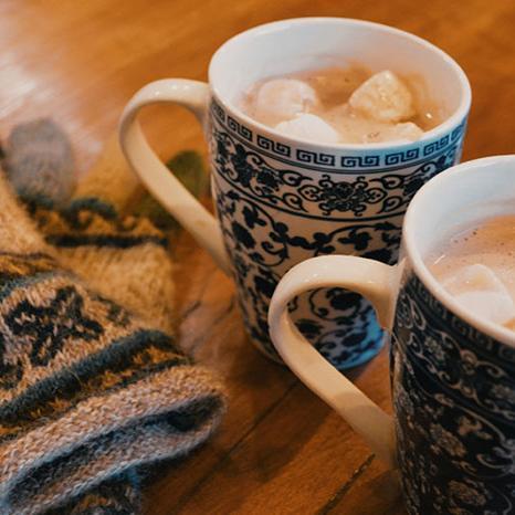 Two mugs of hot cocoa with marshmallows