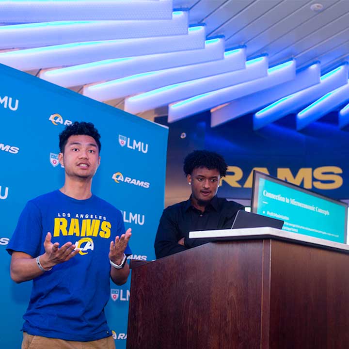 Two students presenting at a podium