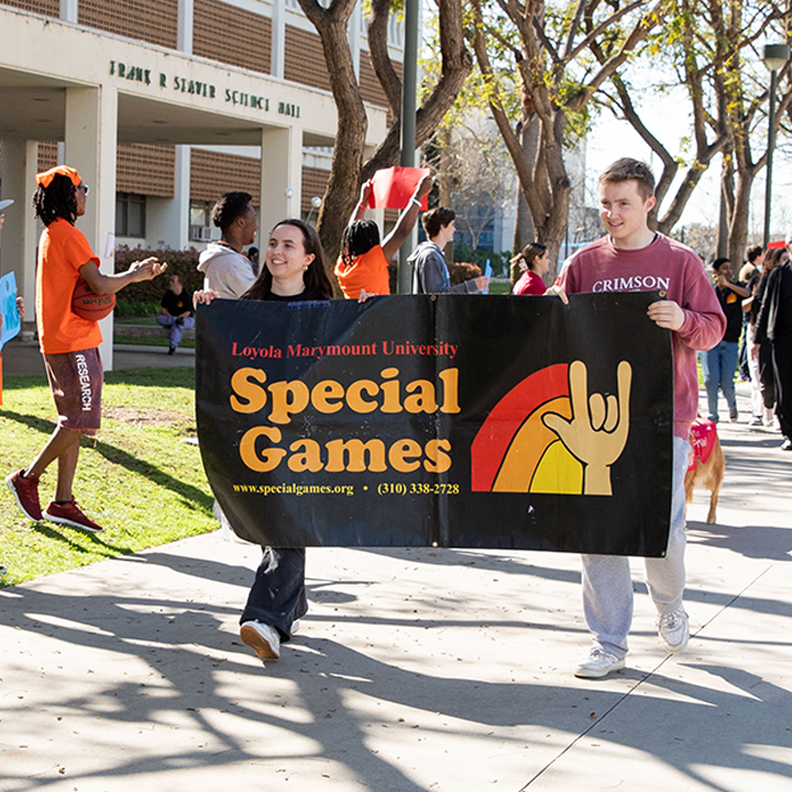 LMU students walking the campus on opening days of the campus special olympics.