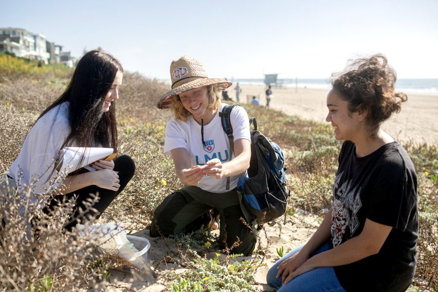 LMU assistant professor of biology, Kate Eisen, in the field with students.