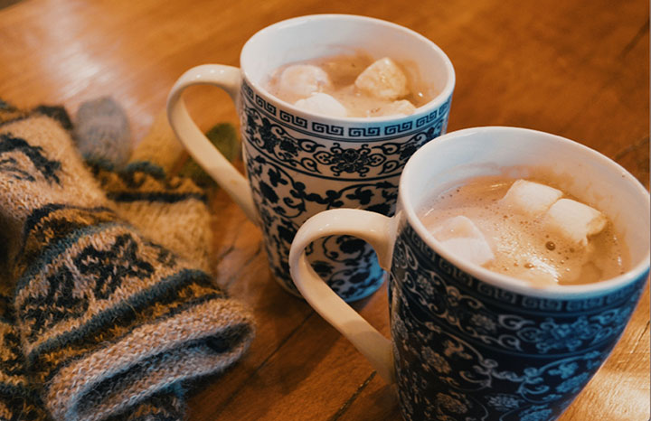 Two mugs of hot cocoa with marshmallows