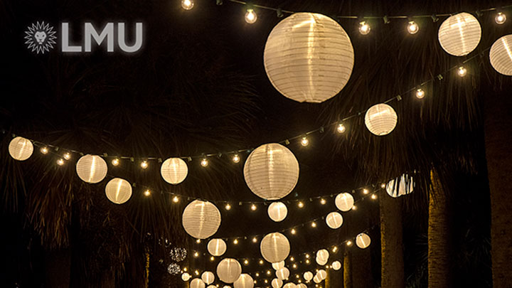 Hanging orb lights in a zigzag pattern through Alumni Mall