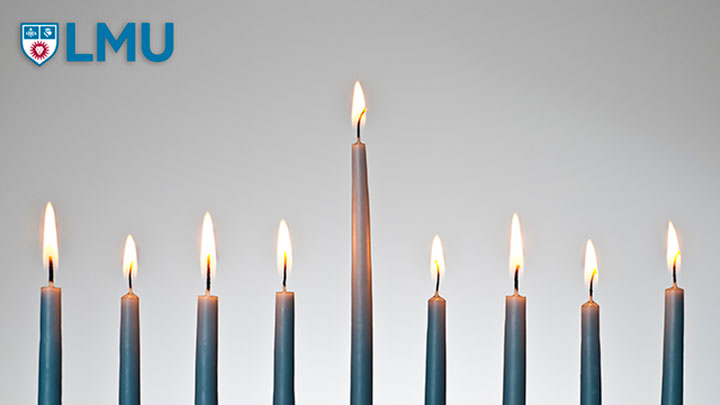 An illuminated Menorah with the LMU logo in the corner