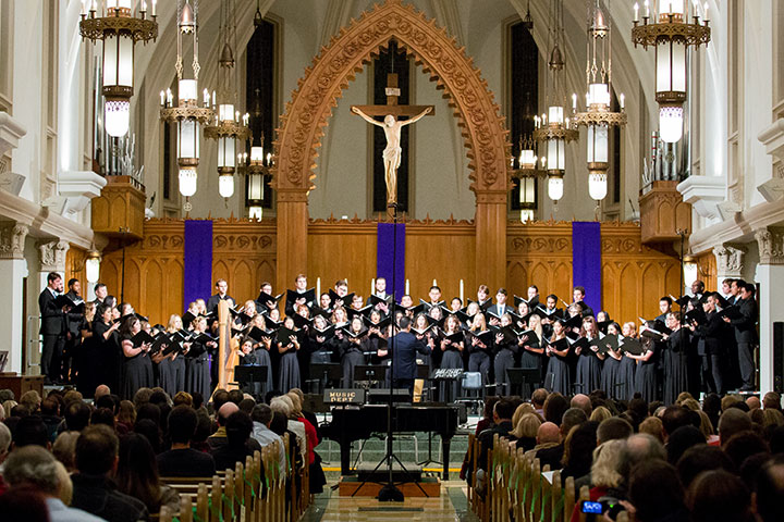Choir performing on the stage in Sacred Heart Chapel