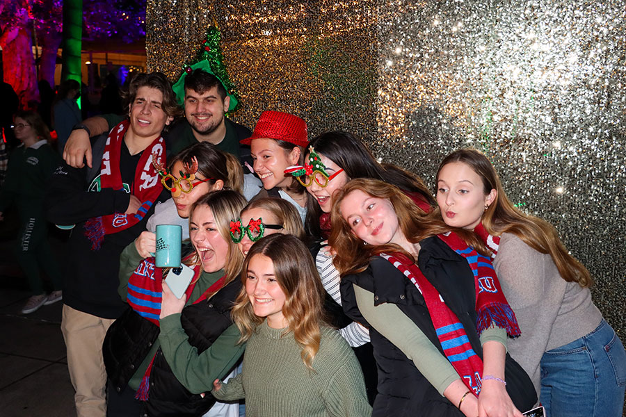 students posing in front of the lights
