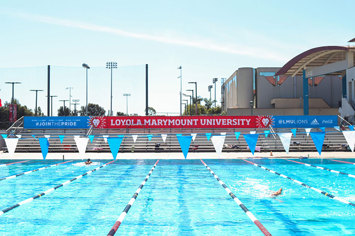 Burns Recreation Center Pool swimming lanes with LMU branding above a nearby seating area