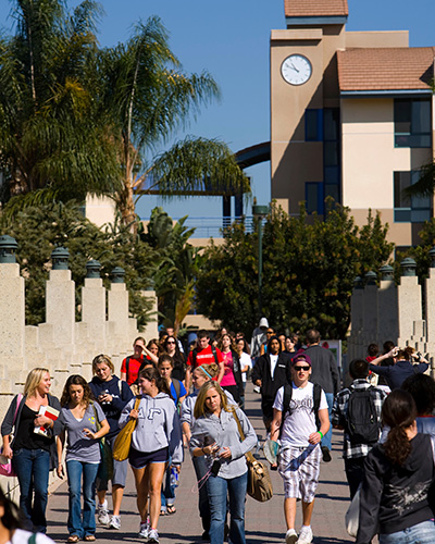 Students walking across LaVecke Bridge