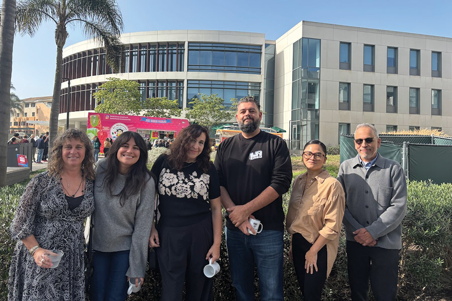 Evelyn McDonnell with (Every Day Is) Taco Tuesday panelists (from left to right): McDonnell, Brittny Mejia (Los Angeles Times), Mandalit del Barco (NPR), Memo Torres (L.A. TACO), Yanira Lemus (Loyola Immigration Law Clinic), and Rubén Martínez (LMU) outside with Taco Trucks in the background.