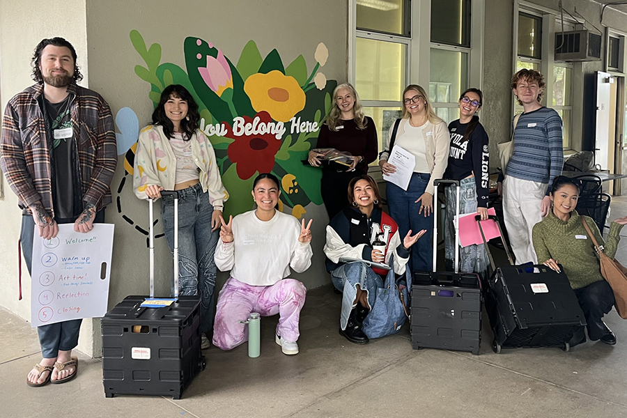 LMU Graduate Students pose in front of elementary school