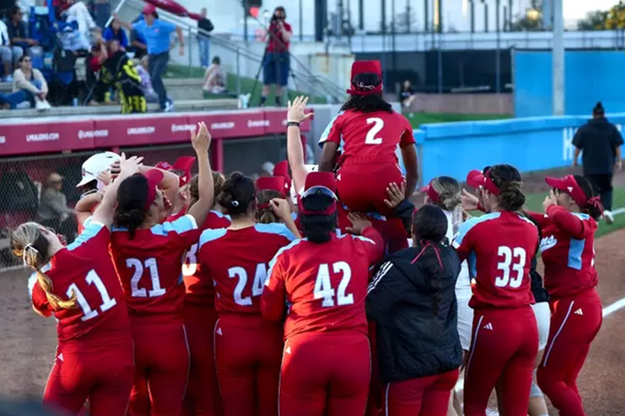 LMU Softball in a team huddle after double header victory