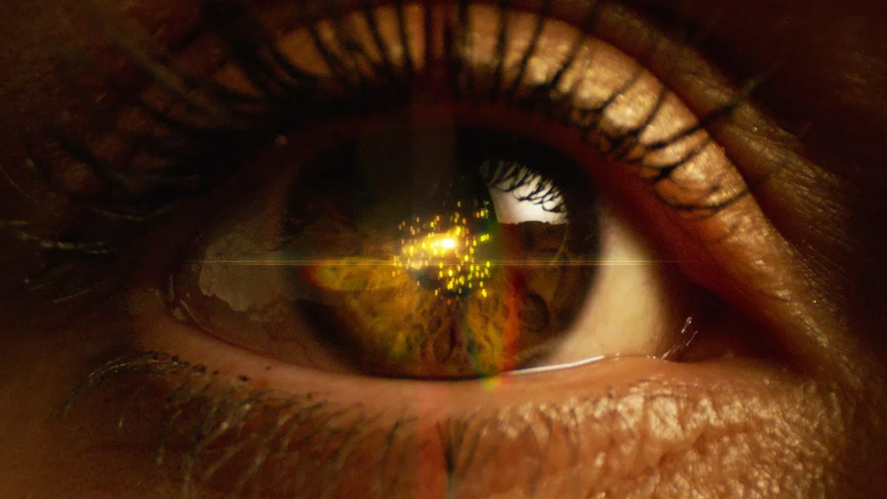 Sparkles being reflected in a close view of a human eye