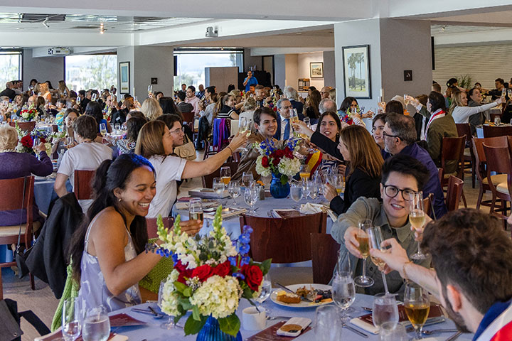 Roski Dining Hall full of attendees participating in a toast