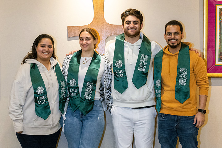 Several Muslim students smiling and wearing LMU MSL sashes