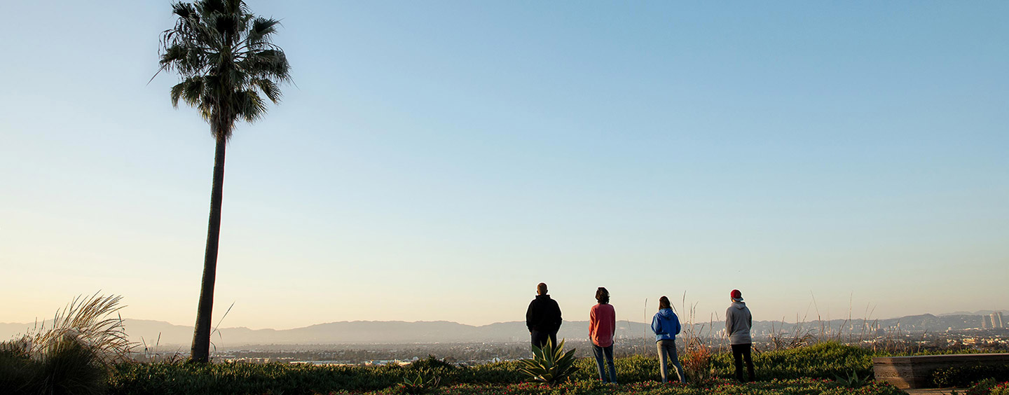 Four students looking out over the bluff