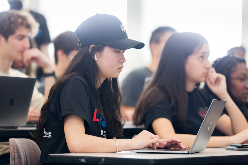 An LMU student reviews MANE Hub on laptop