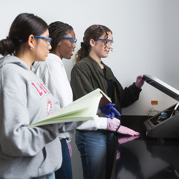 Three LMU students working in a lab