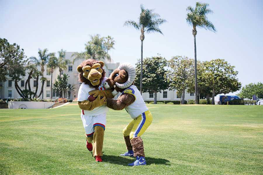 LMU Iggy and L.A. Rams mascot Rampage playing football