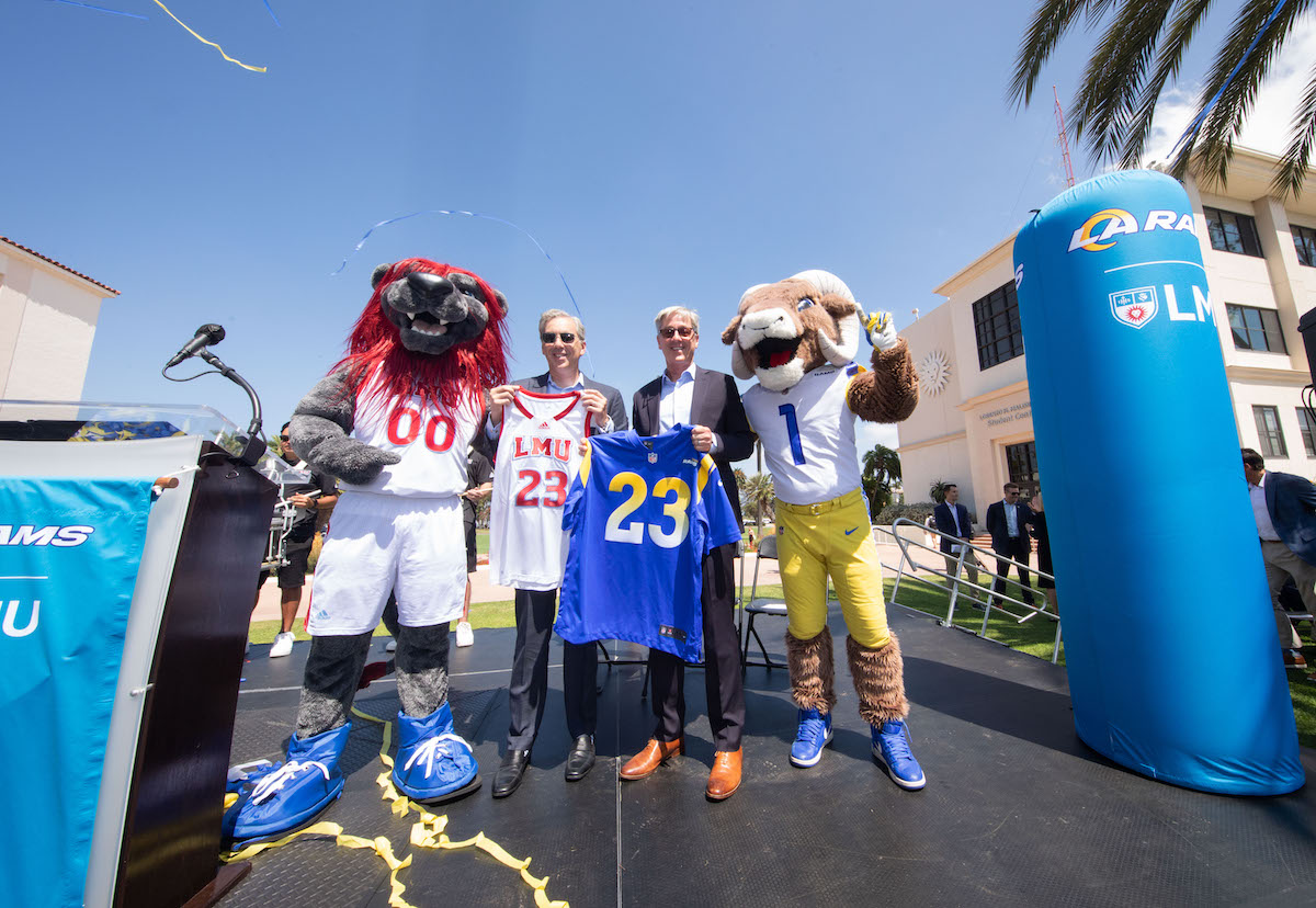 Rams President Kevin Demoff and LMU President Tim Snyder swap jerseys
