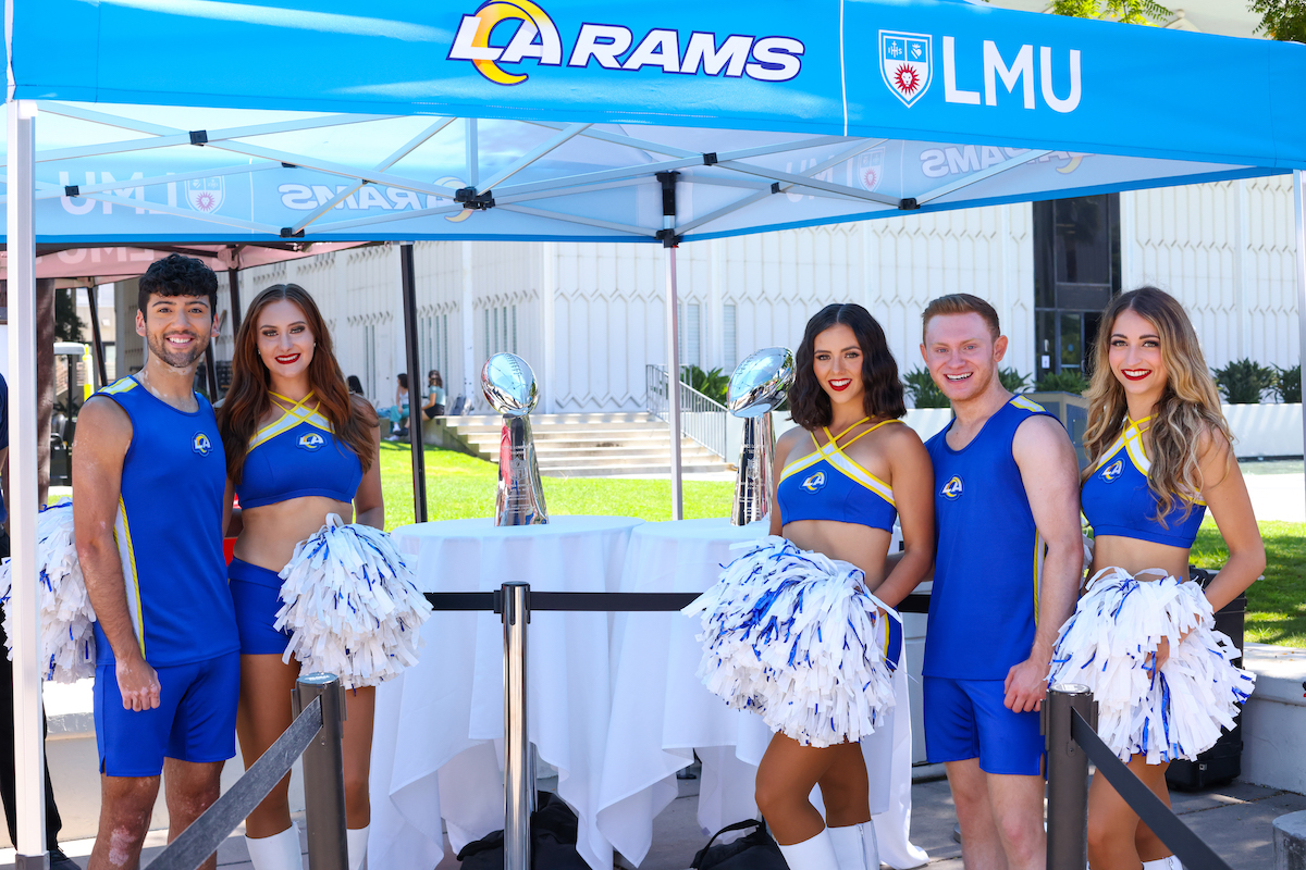 Rams cheerleaders pose with the Lombardi trophies