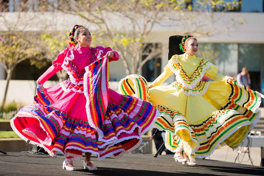 Two Mexican folklorico dancers in traditional dresses