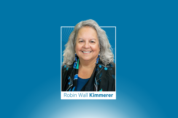 Headshot of Robin Wall Kimmerer on a blue background