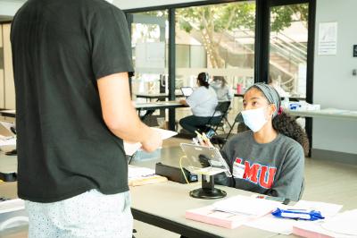 Students check in a voter at the Voting Center on-campus.